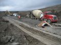 Installed pipe with concrete bedding and cap.