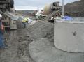 Placing the concrete cap over the pipe.