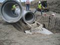 Setting the last pipe segment before setting drop inlet riser.