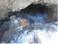 Pipe void with ice on left side of conduit. Arrow indicates concrete cap.