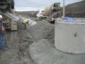 Placing the concrete cap over the pipe.