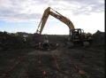 Excavating pipe trench.